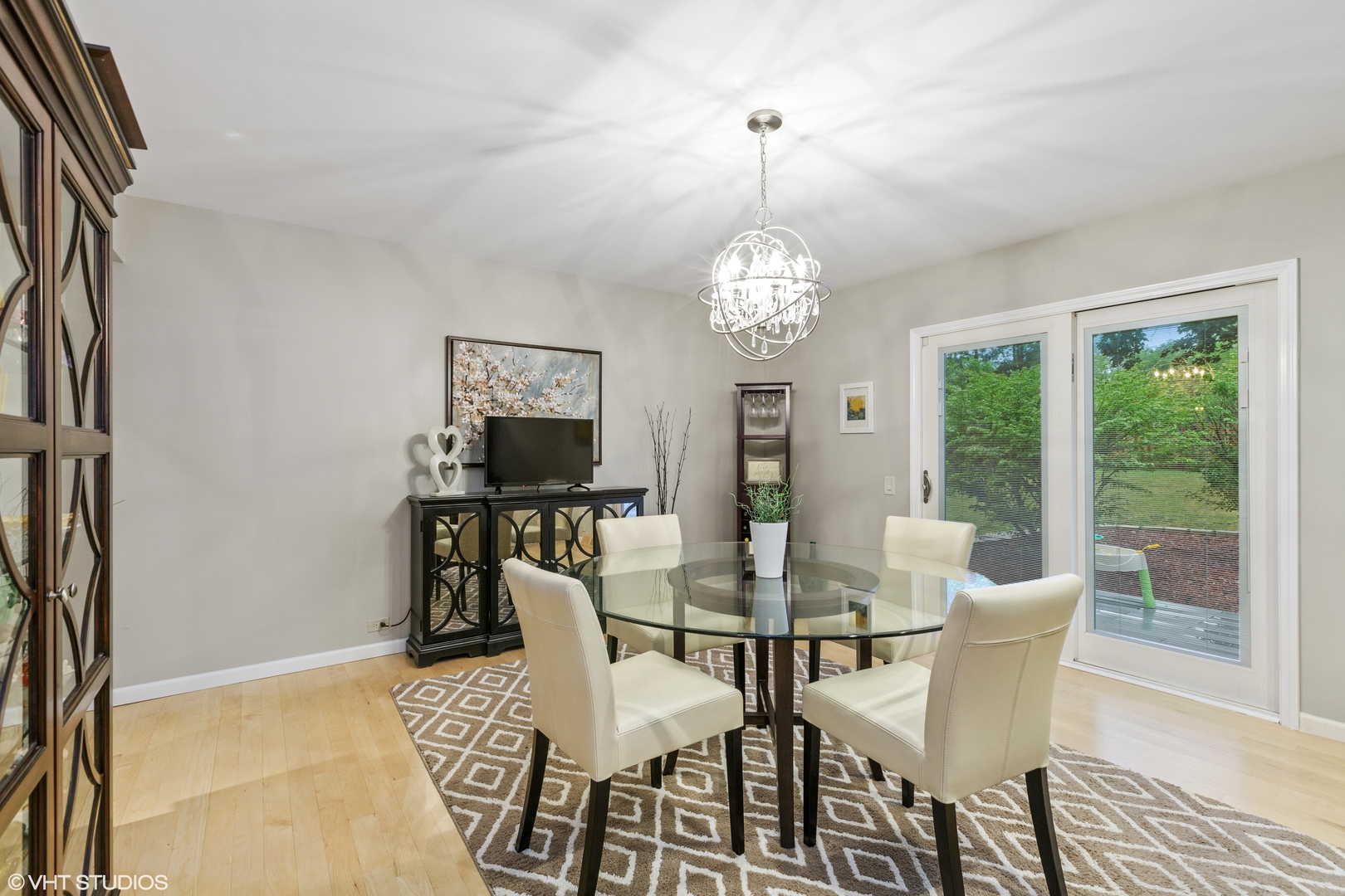 8460 Clynderven Road Burr Ridge, IL 60527 - Photo 8 of 27 a view of a dining room with furniture a chandelier and wooden floor