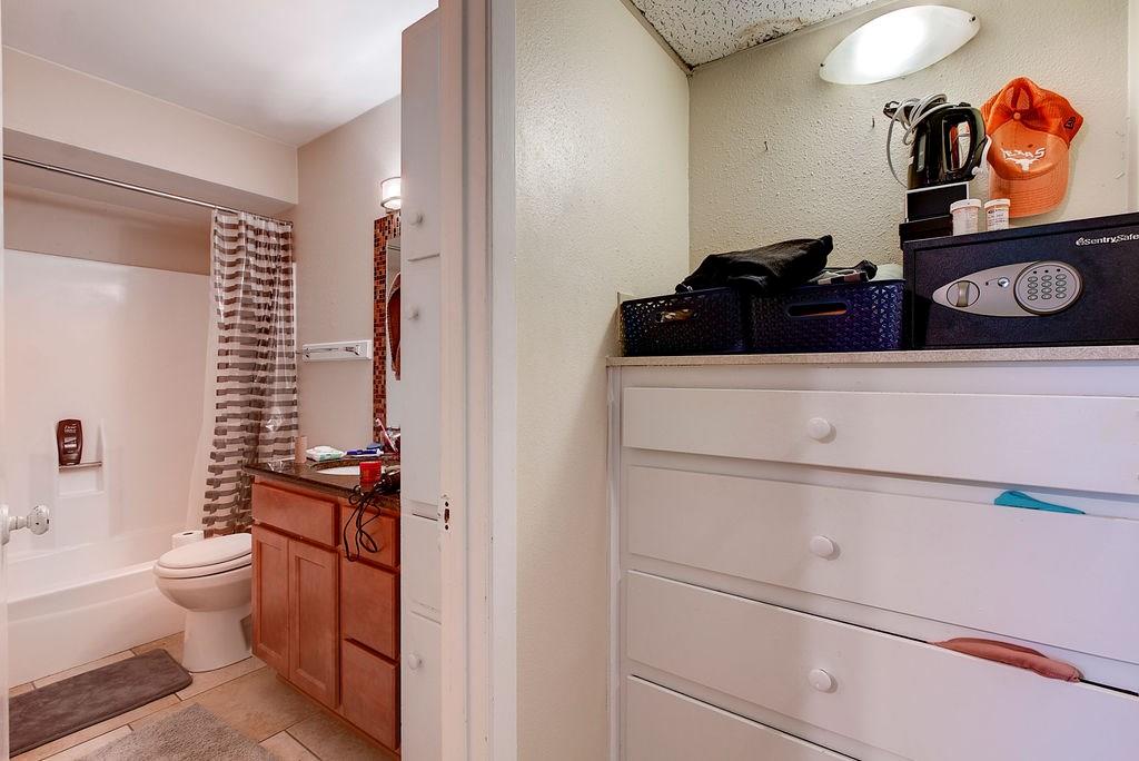 1000 West 26th Street, Unit 216 Austin, TX 78705 - Photo 14 of 16 a bathroom with a toilet a sink and wooden floor
