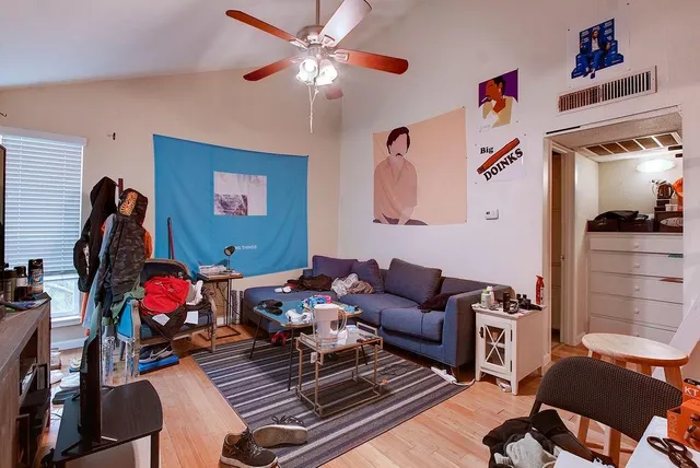 a living room with furniture stairs and a window