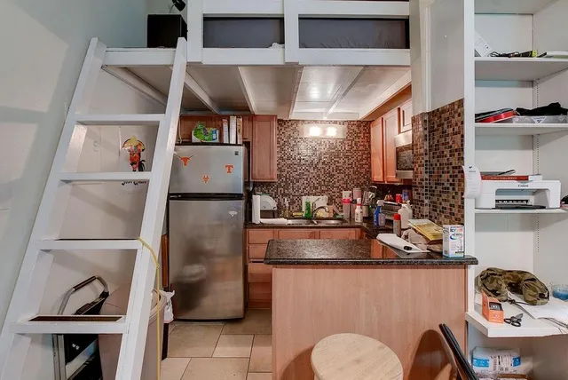a kitchen with a refrigerator and sink