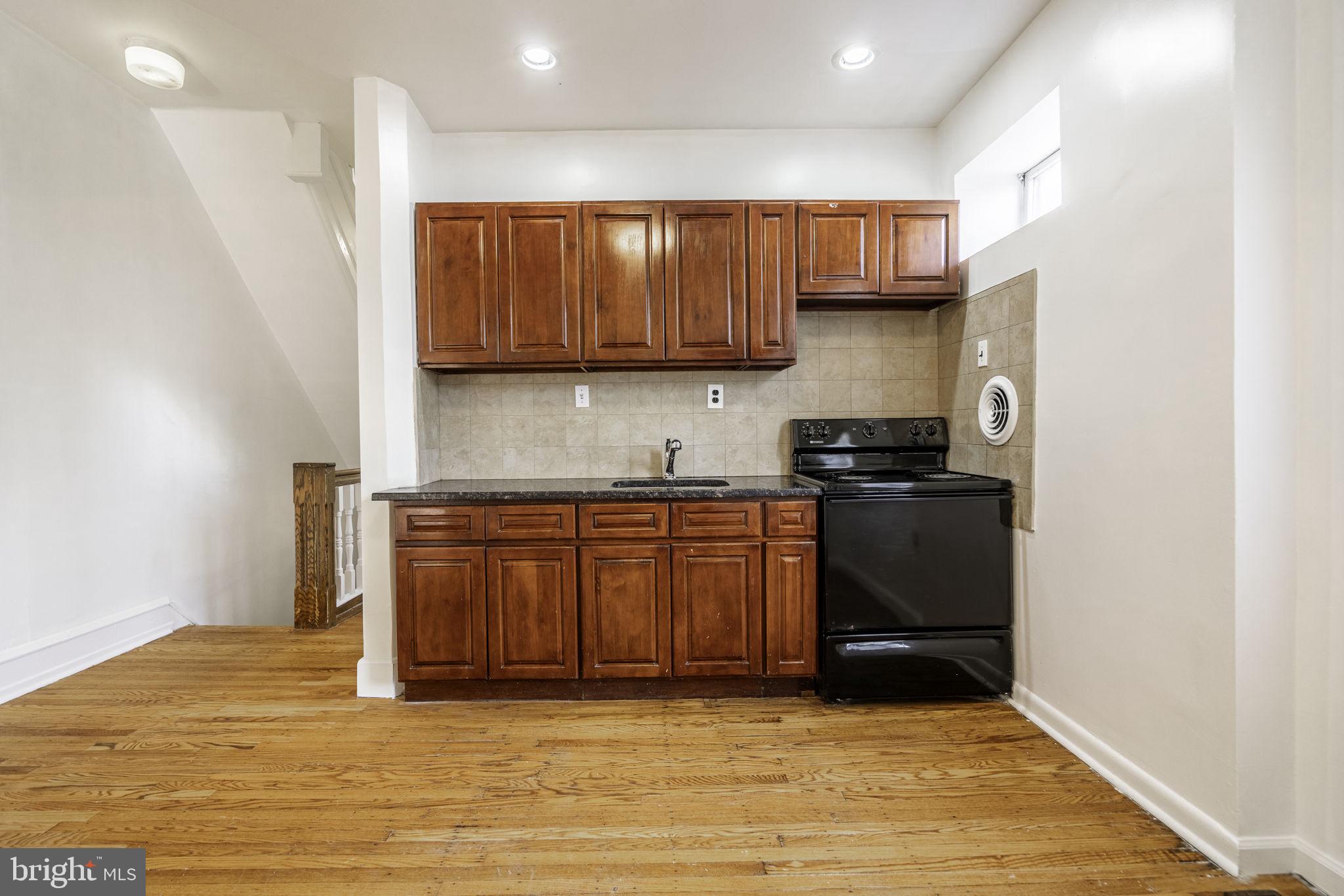 1314 West Ritner Street Philadelphia, PA 19148 - Photo 11 of 19 a kitchen with stainless steel appliances granite countertop a sink stove and cabinets