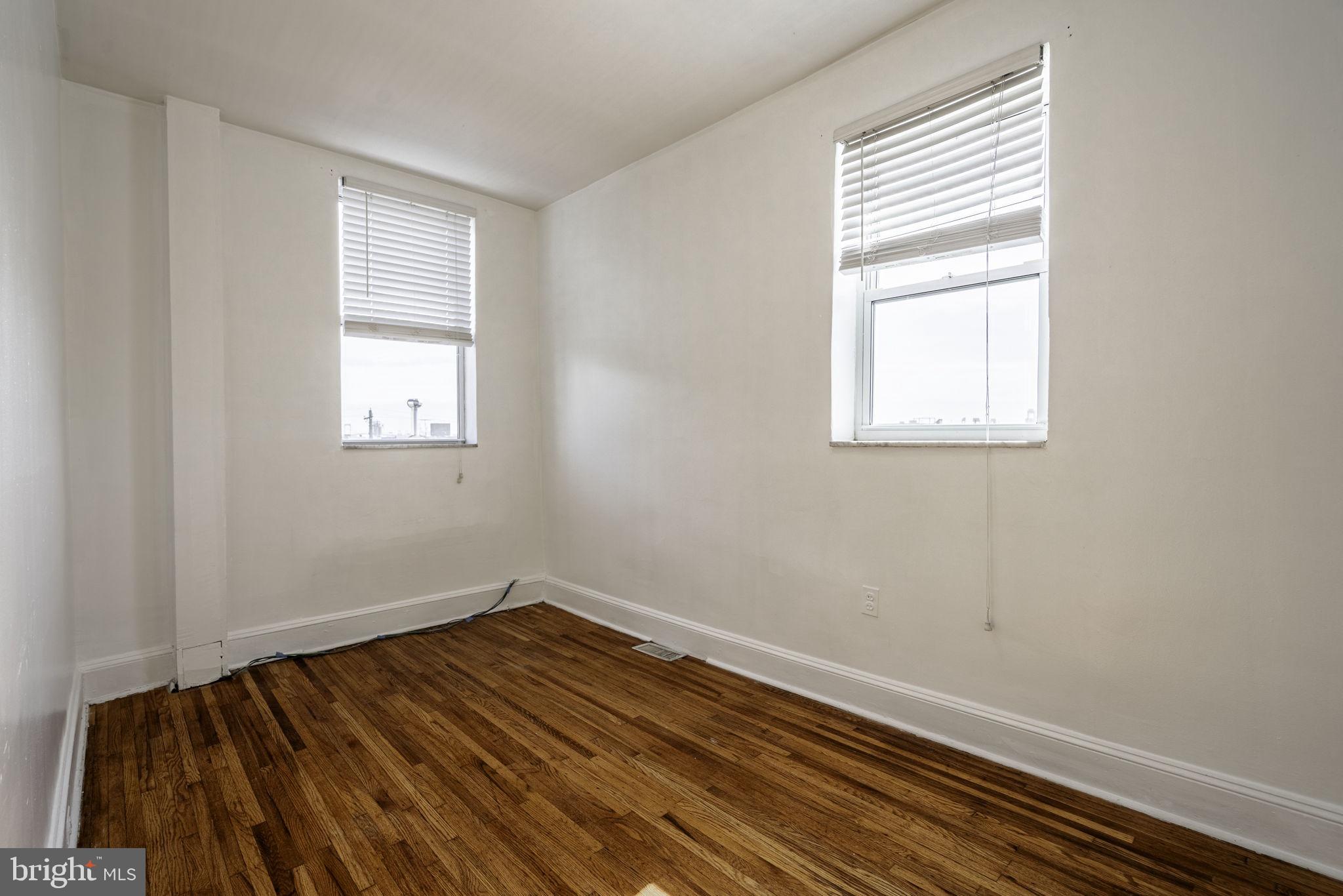 1314 West Ritner Street Philadelphia, PA 19148 - Photo 17 of 19 an empty room with wooden floor and windows