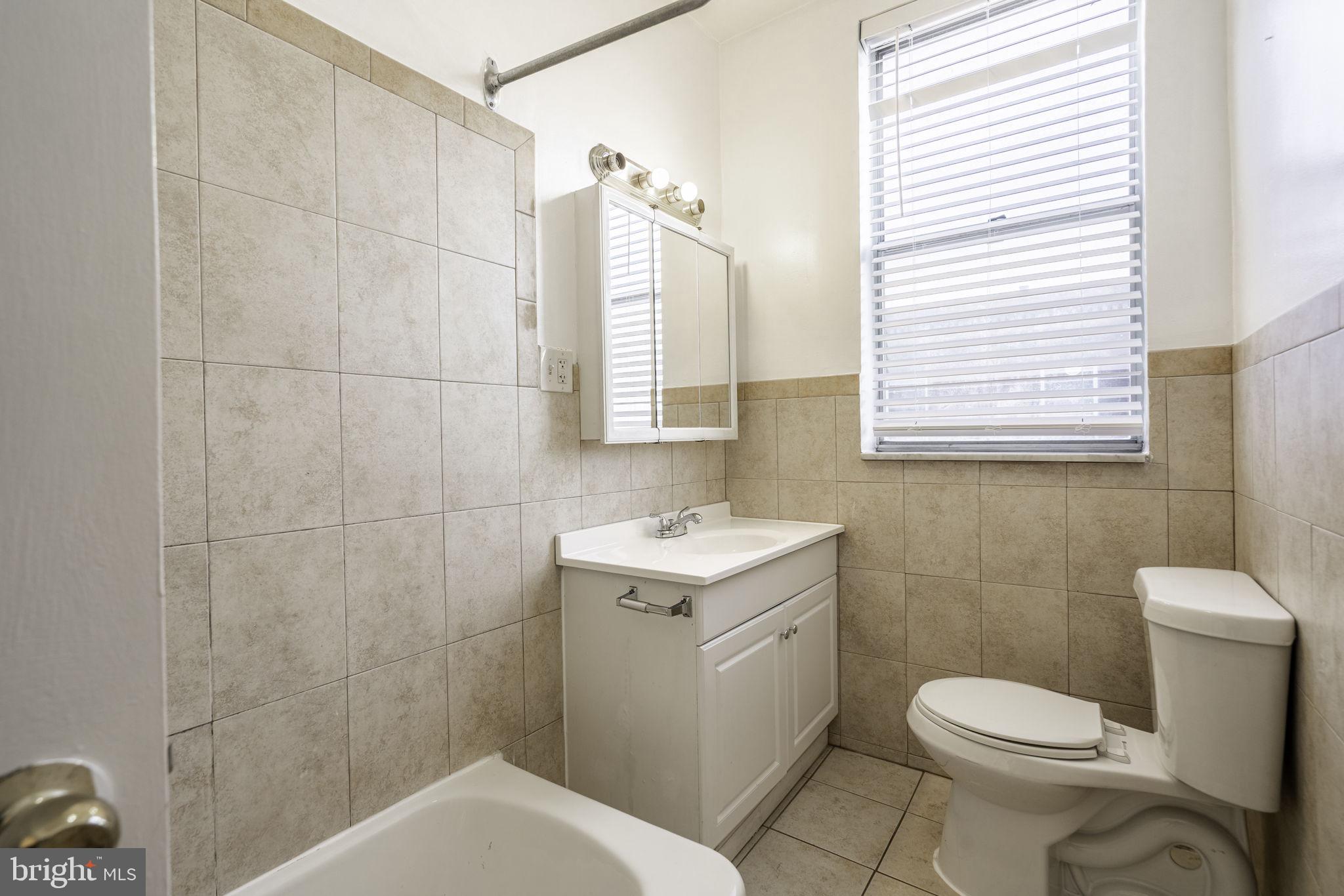 1314 West Ritner Street Philadelphia, PA 19148 - Photo 18 of 19 a bathroom with a sink toilet and mirror