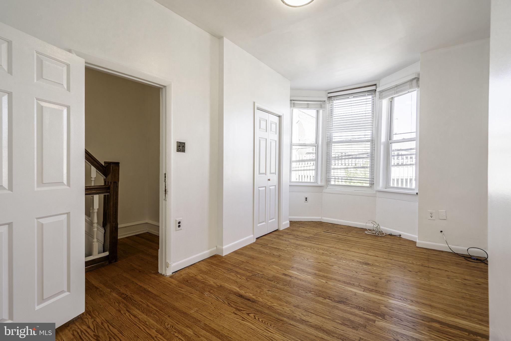 1314 West Ritner Street Philadelphia, PA 19148 - Photo 4 of 19 an empty room with wooden floor and a window