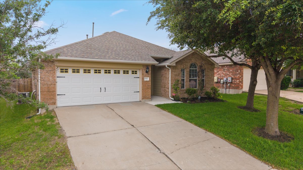 17812 Masi Loop Pflugerville, TX 78660 - Photo 3 of 38 Brick exterior with a gabled roof and an arched window accent