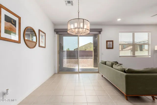 a living room with furniture and a floor to ceiling window