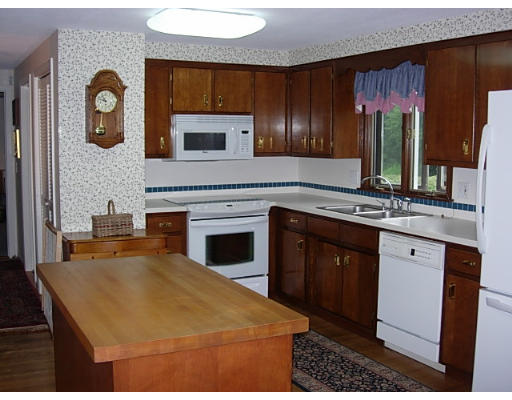 35 Blacksmith Road Wilbraham, MA 01095 - Photo 11 of 18 a kitchen with stainless steel appliances granite countertop a stove a sink and a microwave