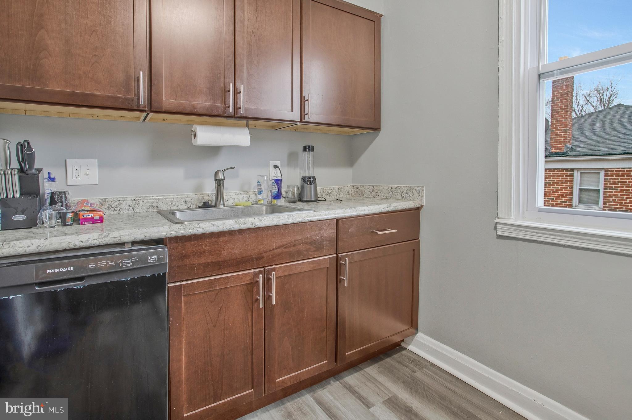 1123 Gleneagle Road Baltimore, MD 21239 - Photo 11 of 40 a kitchen with stainless steel appliances granite countertop a sink stove and cabinets