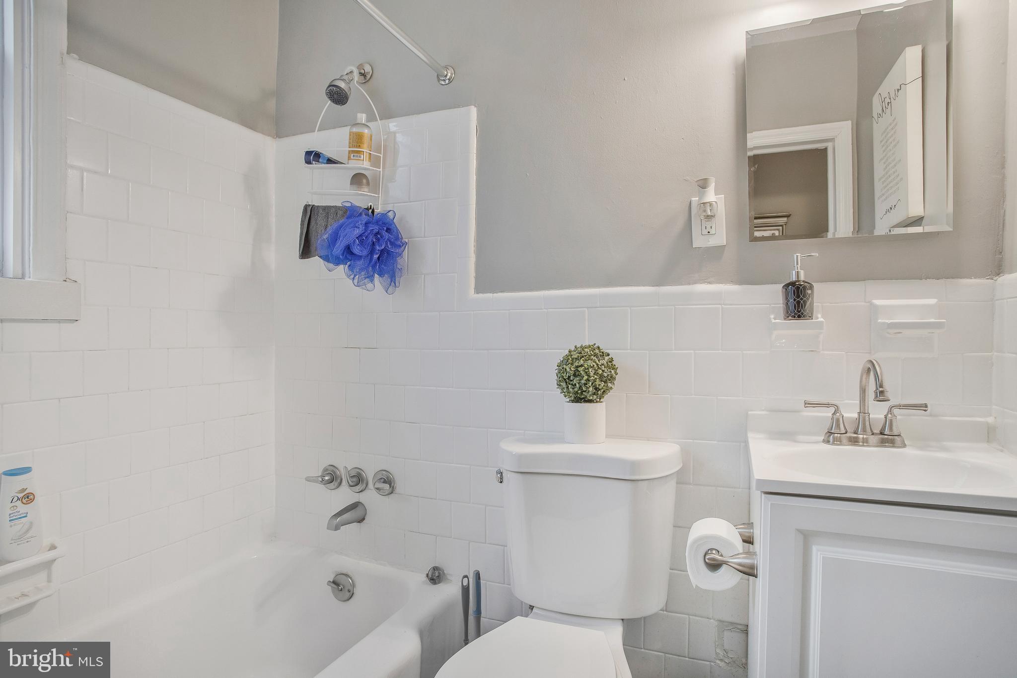 1123 Gleneagle Road Baltimore, MD 21239 - Photo 17 of 40 a bathroom with a sink mirror vanity and toilet