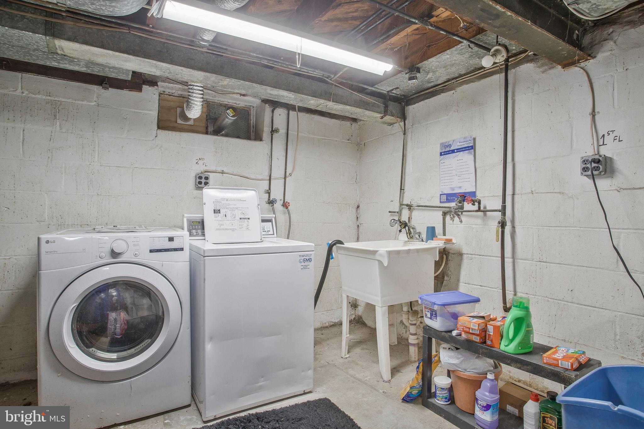 1123 Gleneagle Road Baltimore, MD 21239 - Photo 35 of 40 a utility room with dryer washer and stair