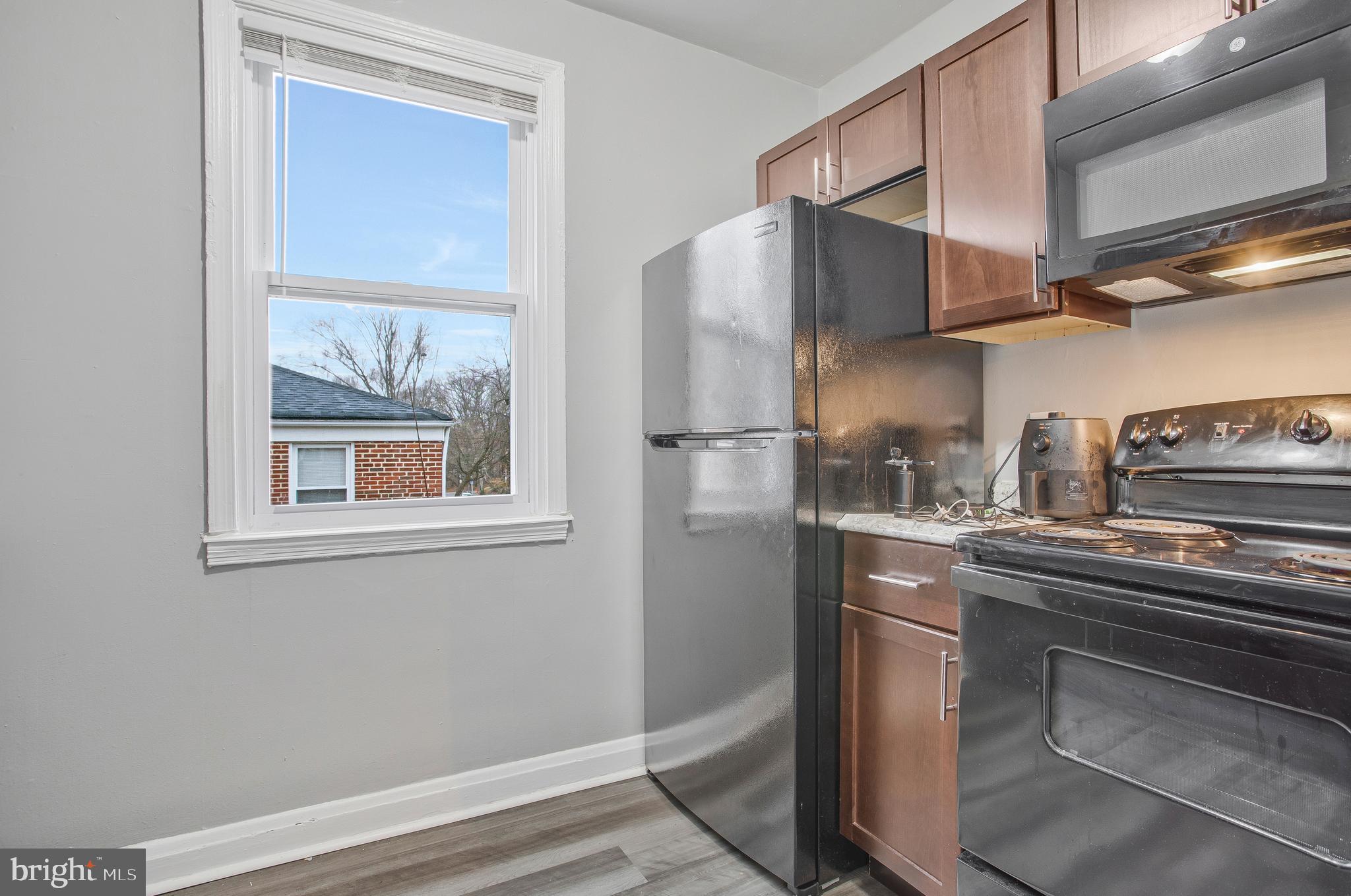 1123 Gleneagle Road Baltimore, MD 21239 - Photo 8 of 40 a kitchen with stainless steel appliances a refrigerator and stove
