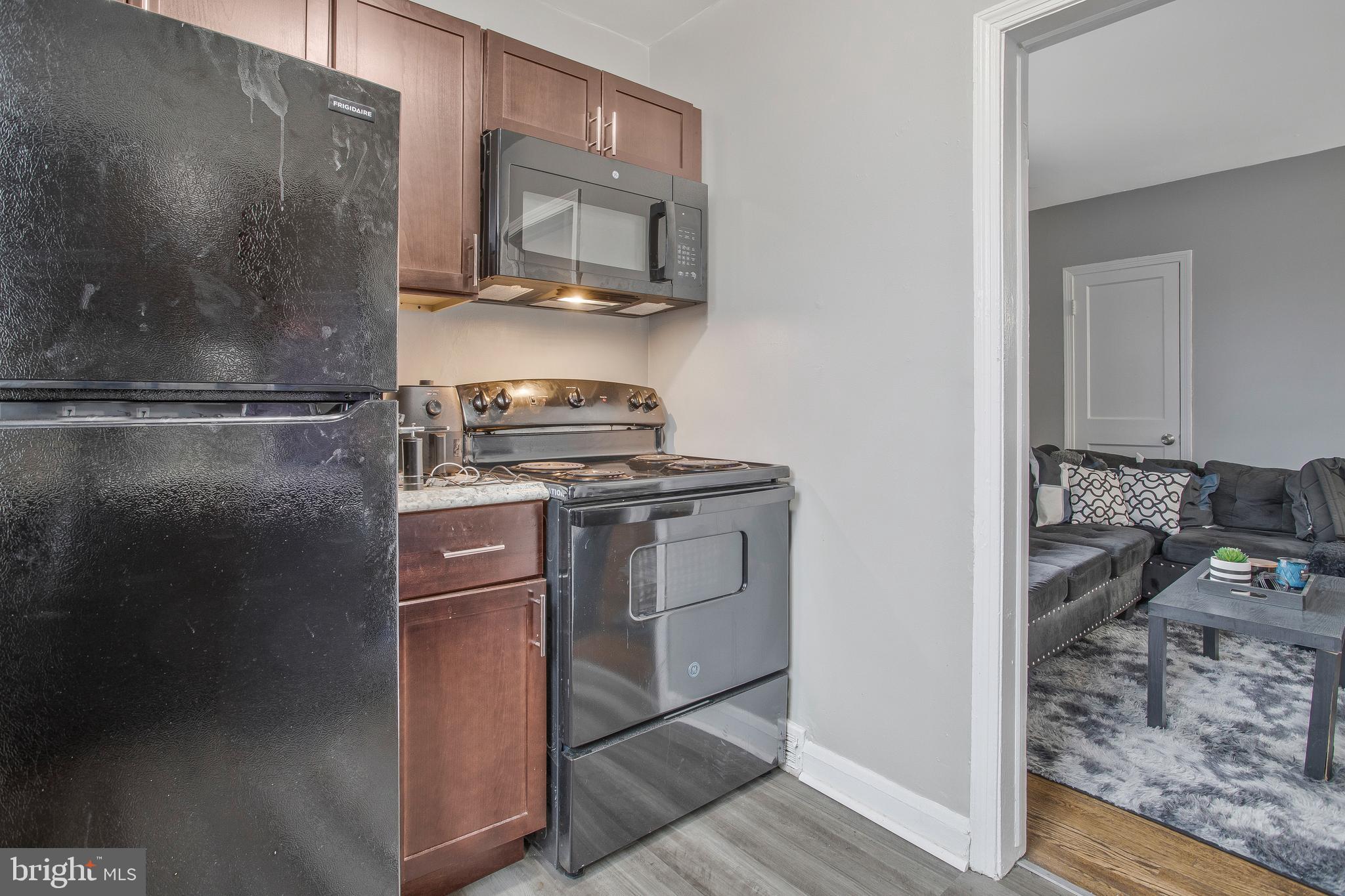1123 Gleneagle Road Baltimore, MD 21239 - Photo 9 of 40 a kitchen with a refrigerator stove and microwave