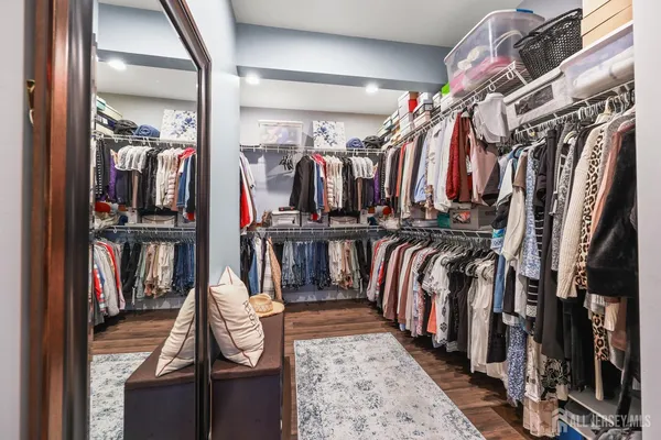 a spacious bathroom with a double vanity sink a mirror and a shower