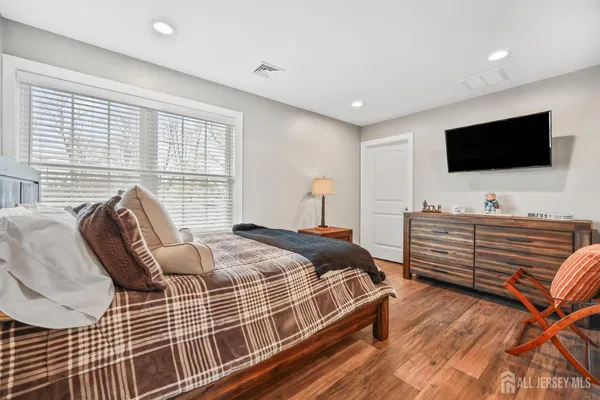 a en suite bathroom with a granite countertop sink and a mirror