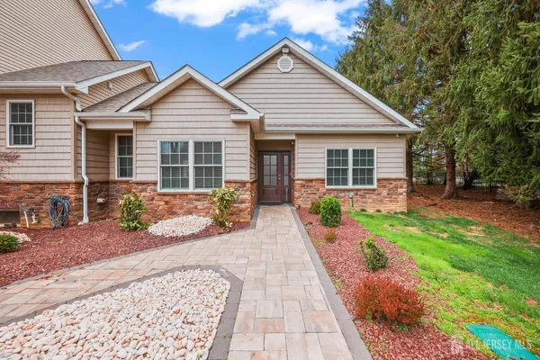 a front view of a house with large windows
