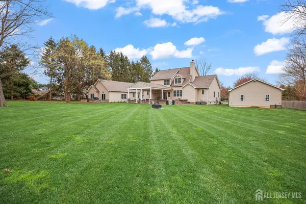 a spacious bedroom with a bed and wooden floor