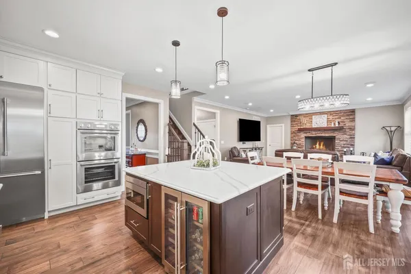 a large kitchen with kitchen island a island a sink a stove and a center island