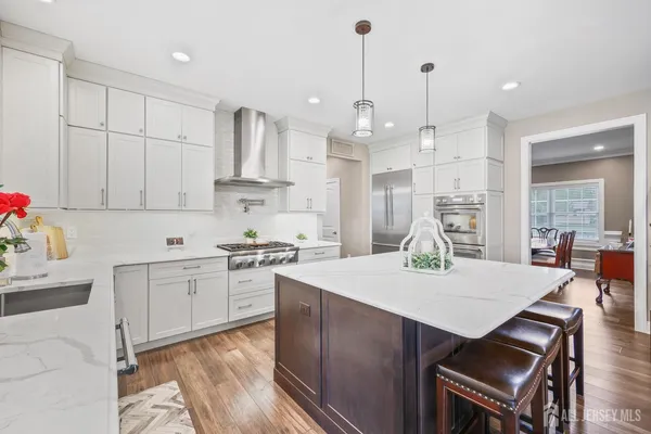 a kitchen with stainless steel appliances granite countertop a sink stove and cabinets