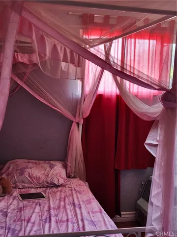 a bed sitting in a bedroom next to a window