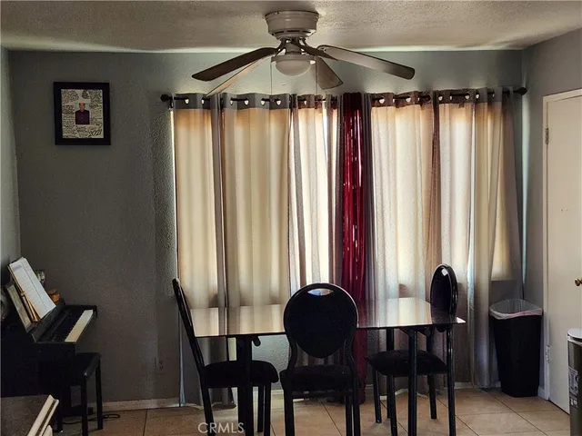 a view of a dining room with furniture and a window