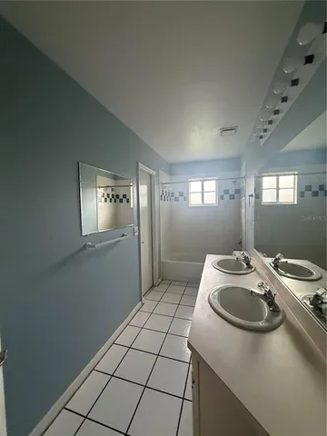 a bathroom with a sink a toilet and mirror