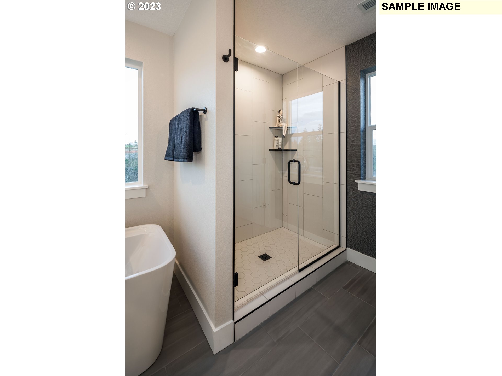 935 Northwest 178th Street Ridgefield, WA 98642 - Photo 18 of 24 a bathroom with a glass shower door