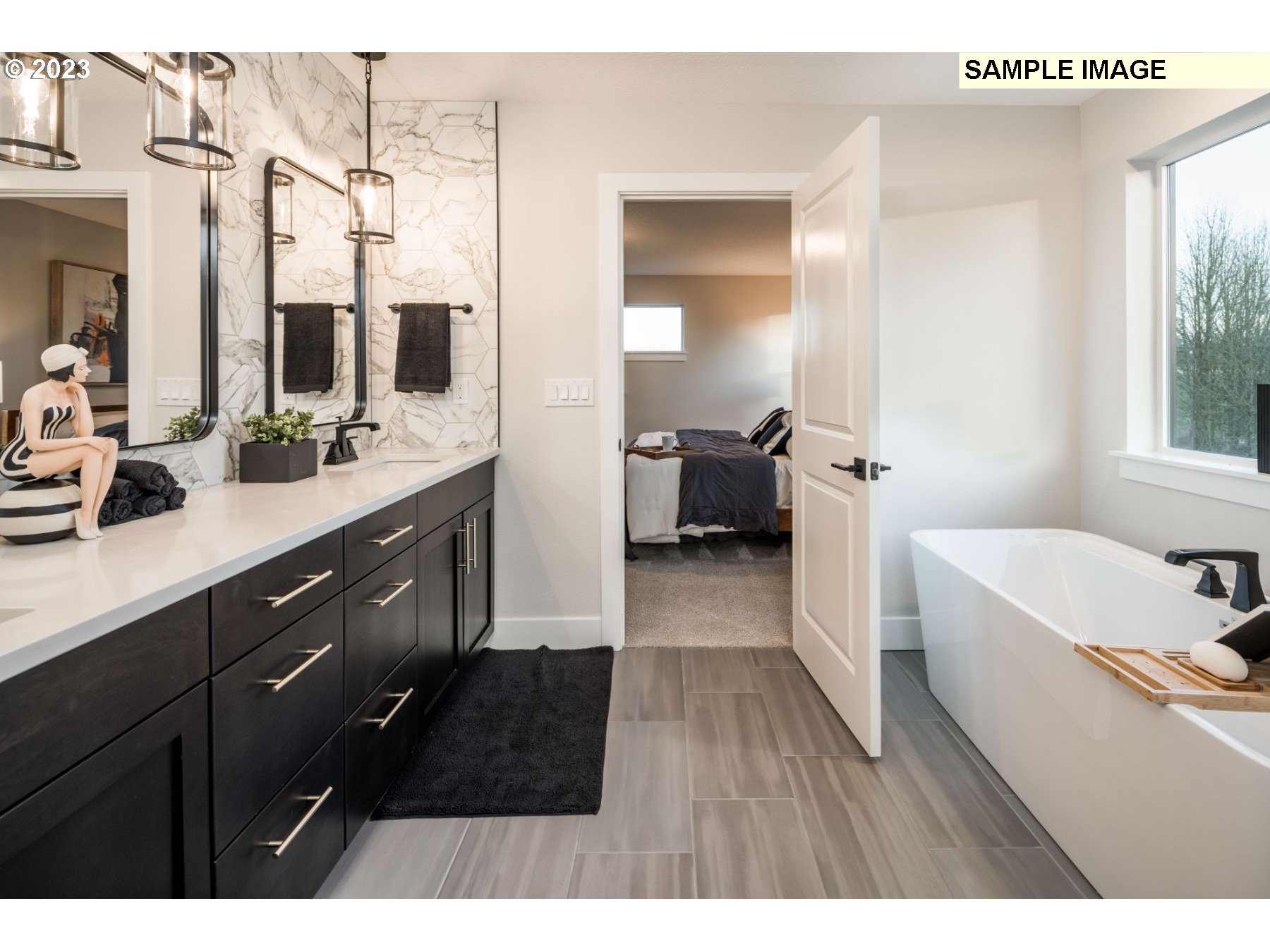 935 Northwest 178th Street Ridgefield, WA 98642 - Photo 19 of 24 a spacious bathroom with a tub double vanity sink a window and a mirror