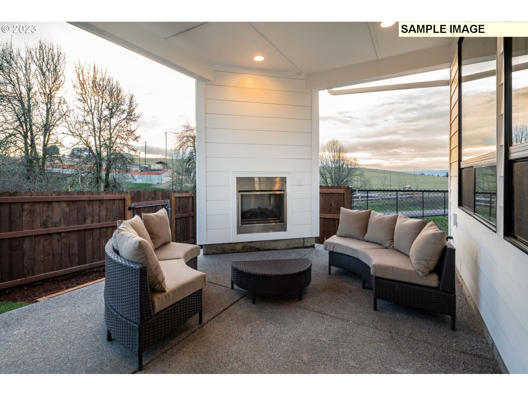 935 Northwest 178th Street Ridgefield, WA 98642 - Photo 23 of 24 a living room with furniture a fireplace and a floor to ceiling window