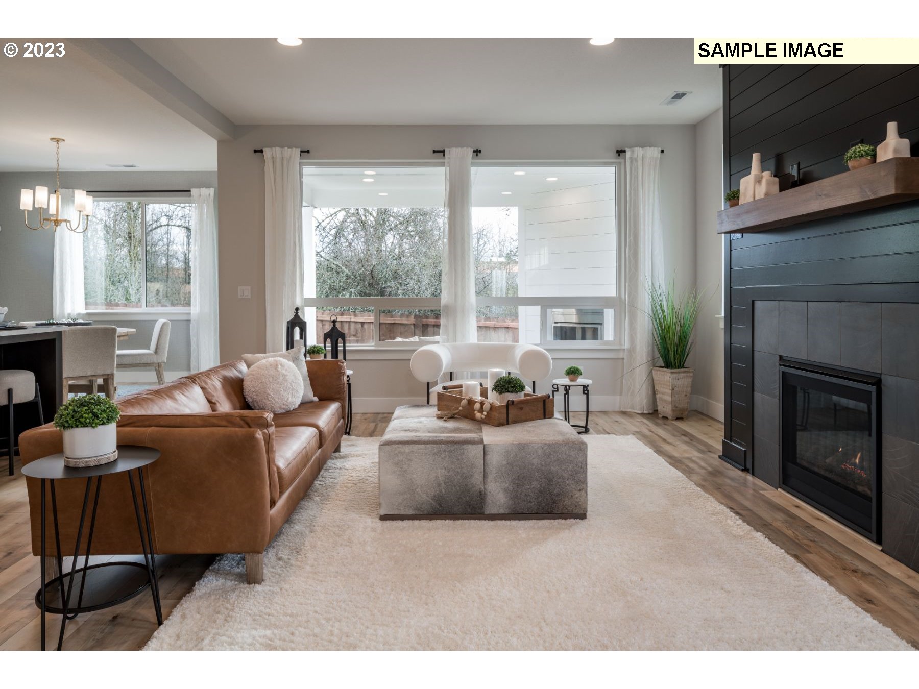935 Northwest 178th Street Ridgefield, WA 98642 - Photo 5 of 24 a living room with furniture large window and a fireplace