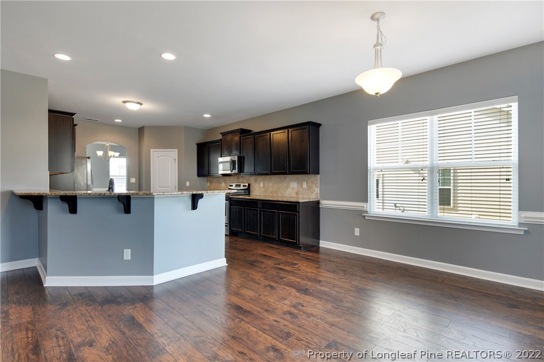 826 Harry Truman Road Fayetteville, NC 28311 - Photo 11 of 48 a view of kitchen with microwave a stove and a refrigerator