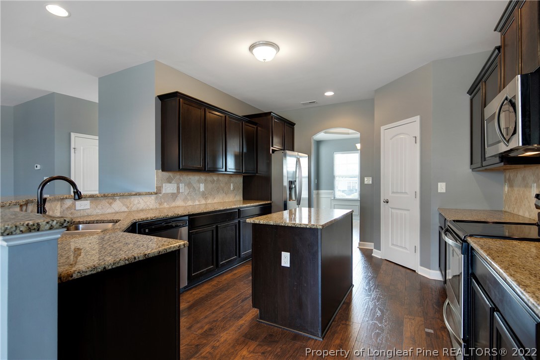 826 Harry Truman Road Fayetteville, NC 28311 - Photo 14 of 48 a kitchen with stainless steel appliances granite countertop a sink stove and cabinets