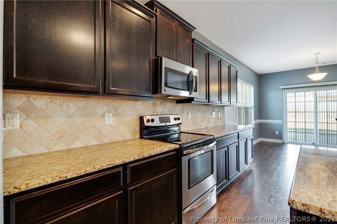 826 Harry Truman Road Fayetteville, NC 28311 - Photo 17 of 48 a kitchen with stainless steel appliances granite countertop a stove a sink and a microwave