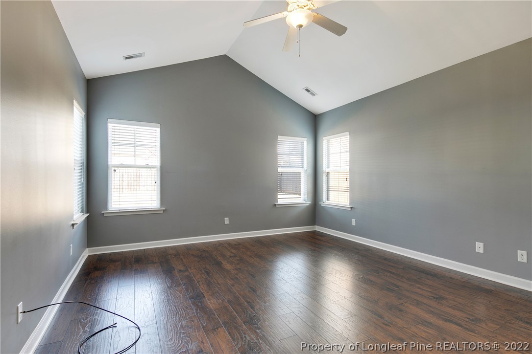 826 Harry Truman Road Fayetteville, NC 28311 - Photo 21 of 48 an empty room with wooden floor and windows