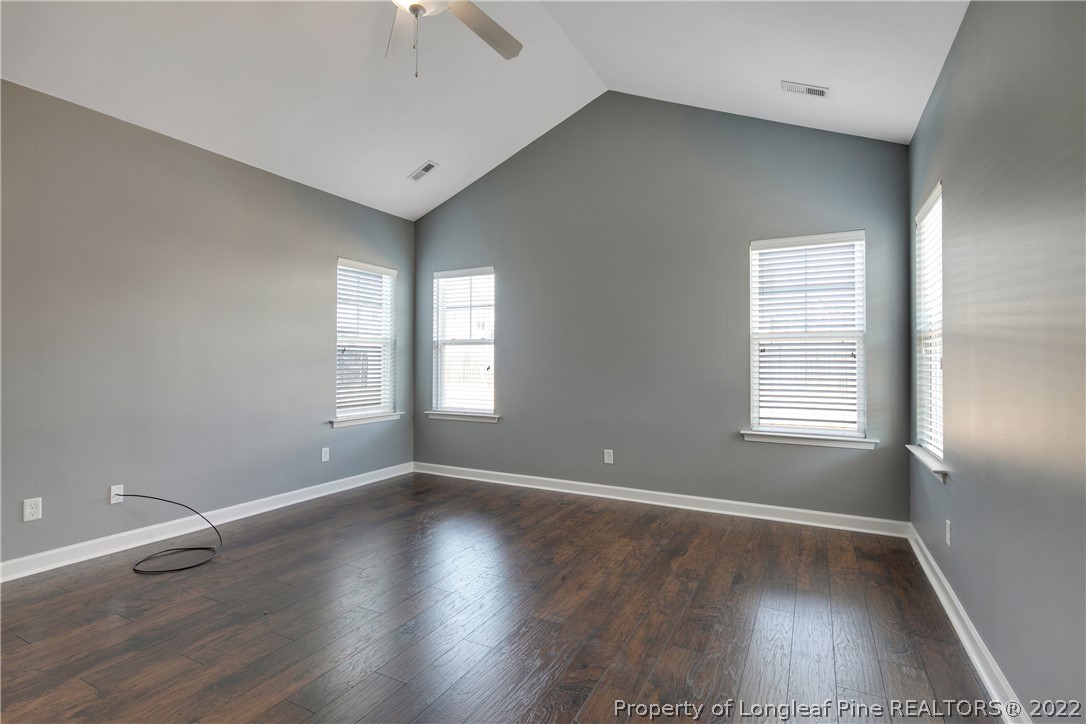 826 Harry Truman Road Fayetteville, NC 28311 - Photo 24 of 48 an empty room with wooden floor and windows
