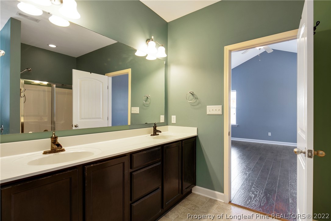826 Harry Truman Road Fayetteville, NC 28311 - Photo 26 of 48 a bathroom with a double vanity sink and a mirror