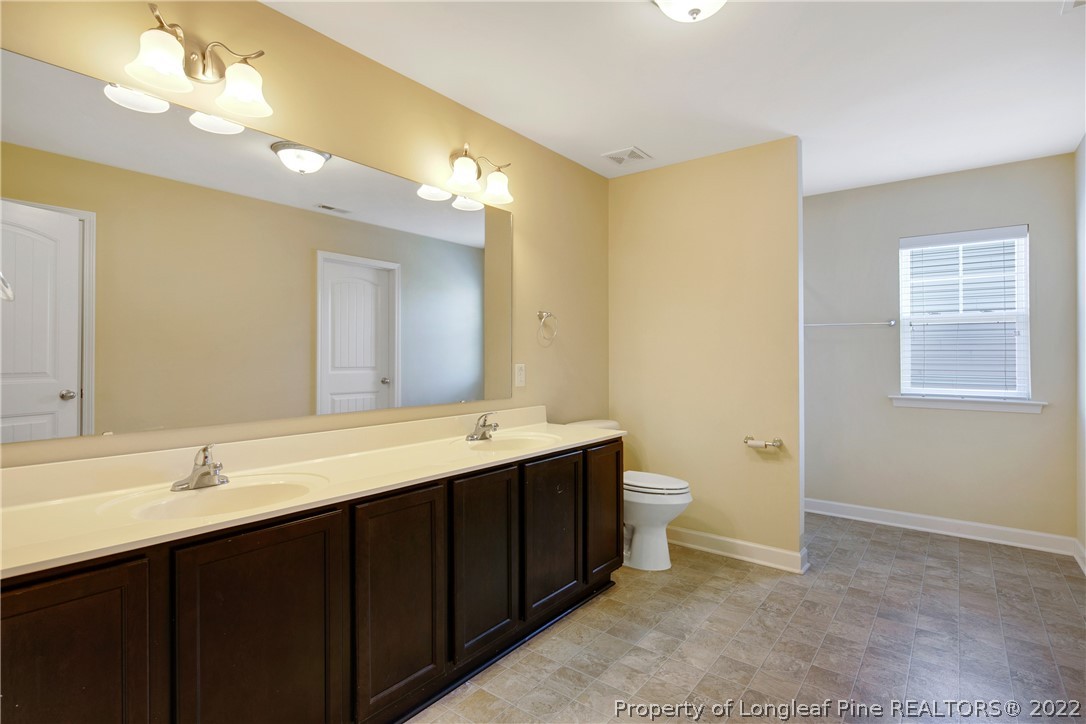 826 Harry Truman Road Fayetteville, NC 28311 - Photo 34 of 48 a bathroom with a double vanity sink mirror and toilet