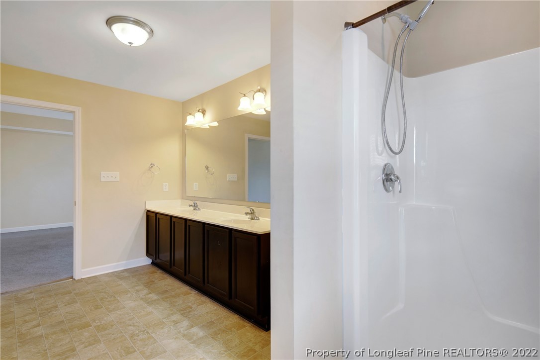 826 Harry Truman Road Fayetteville, NC 28311 - Photo 35 of 48 a bathroom with a sink and mirror