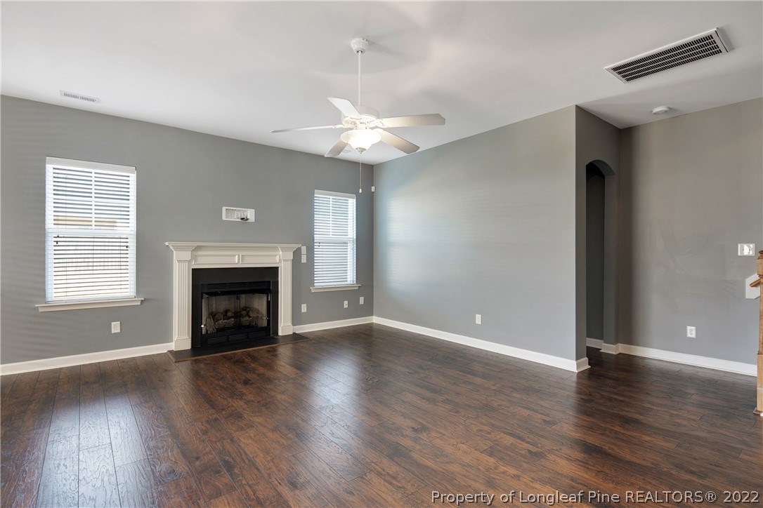 826 Harry Truman Road Fayetteville, NC 28311 - Photo 7 of 48 a view of an empty room with wooden floor fireplace and a window