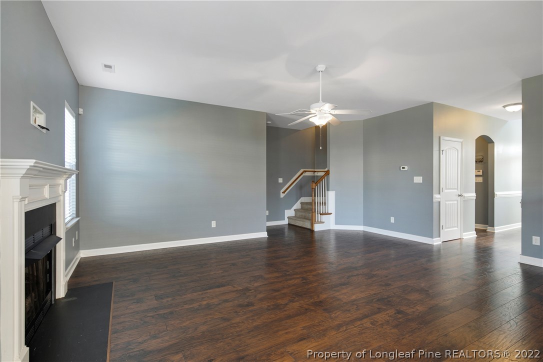 826 Harry Truman Road Fayetteville, NC 28311 - Photo 8 of 48 a view of an empty room with wooden floor and a fireplace