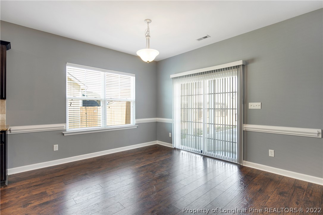826 Harry Truman Road Fayetteville, NC 28311 - Photo 10 of 48 an empty room with wooden floor and windows