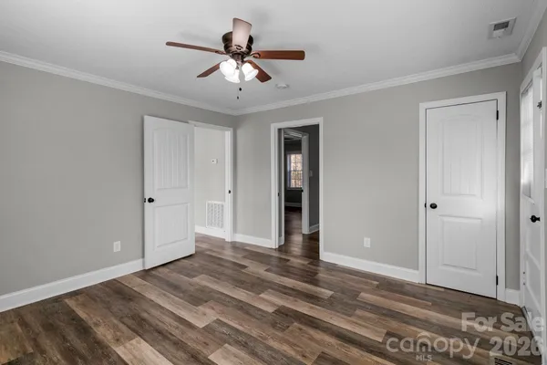 a view of an empty room with wooden floor