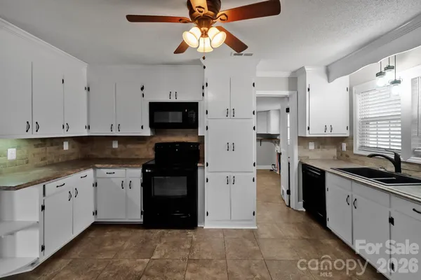 a kitchen with stainless steel appliances granite countertop a sink and a stove