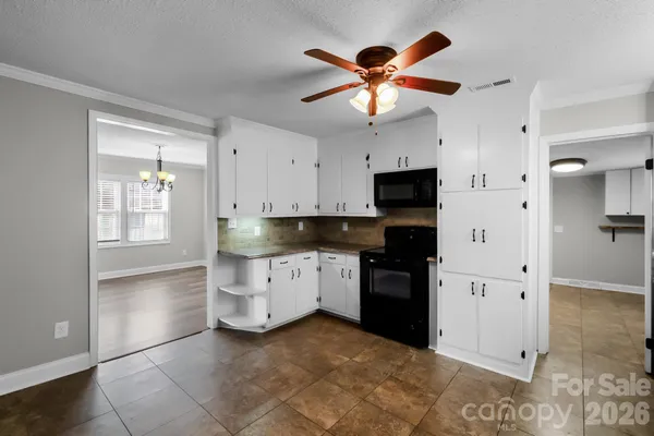a kitchen with stainless steel appliances kitchen island granite countertop a refrigerator and a sink