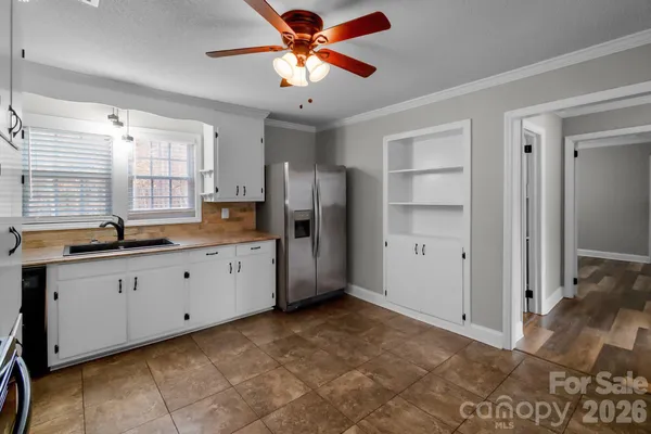a kitchen with granite countertop a refrigerator and a sink