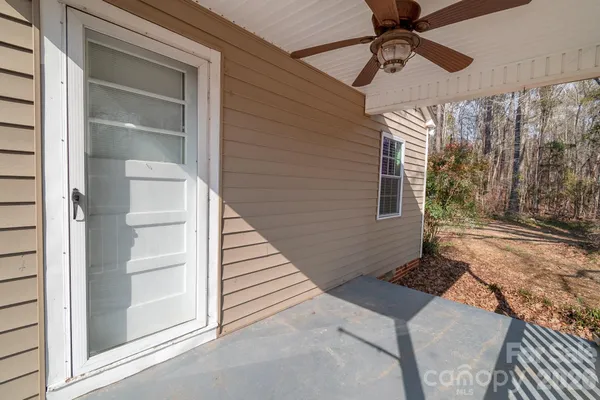 a view of a house with a door and wooden floor