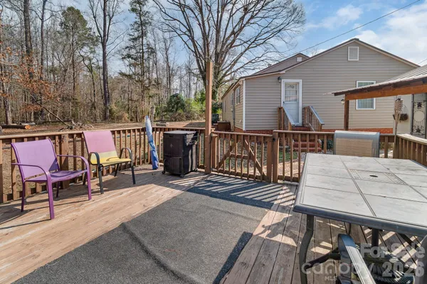 a view of a roof deck with two couches and wooden floor