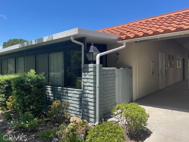 852 Ronda Mendoza, Unit Q Laguna Woods, CA 92637 - Photo 2 of 20 a front view of a house with a yard