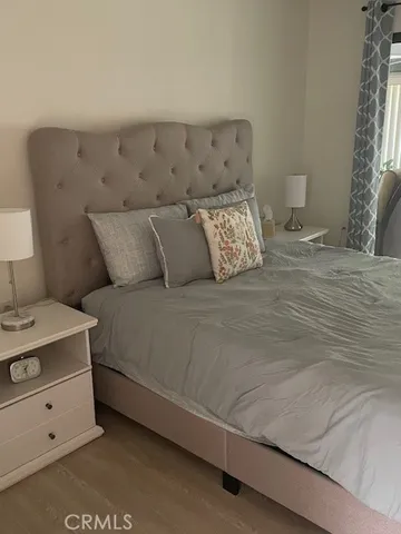 a bed sitting in a bedroom with a lamp