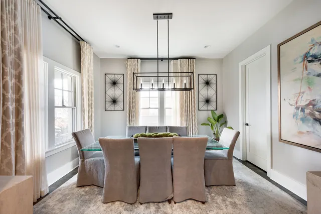 a living room with furniture a rug and a window