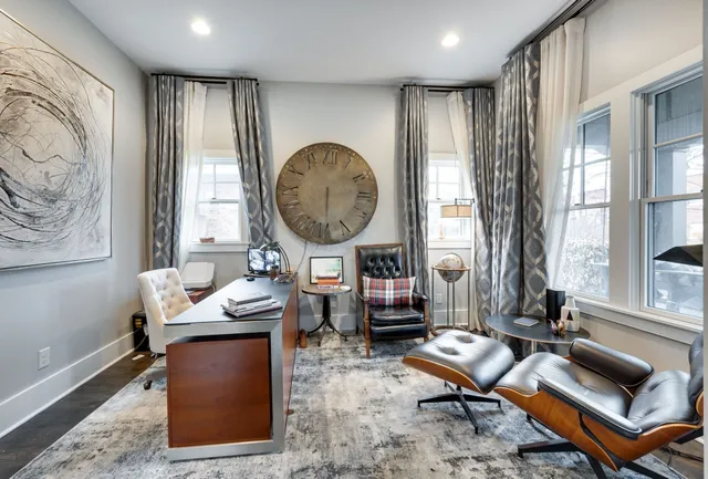 a dining room with furniture entryway and wooden floor